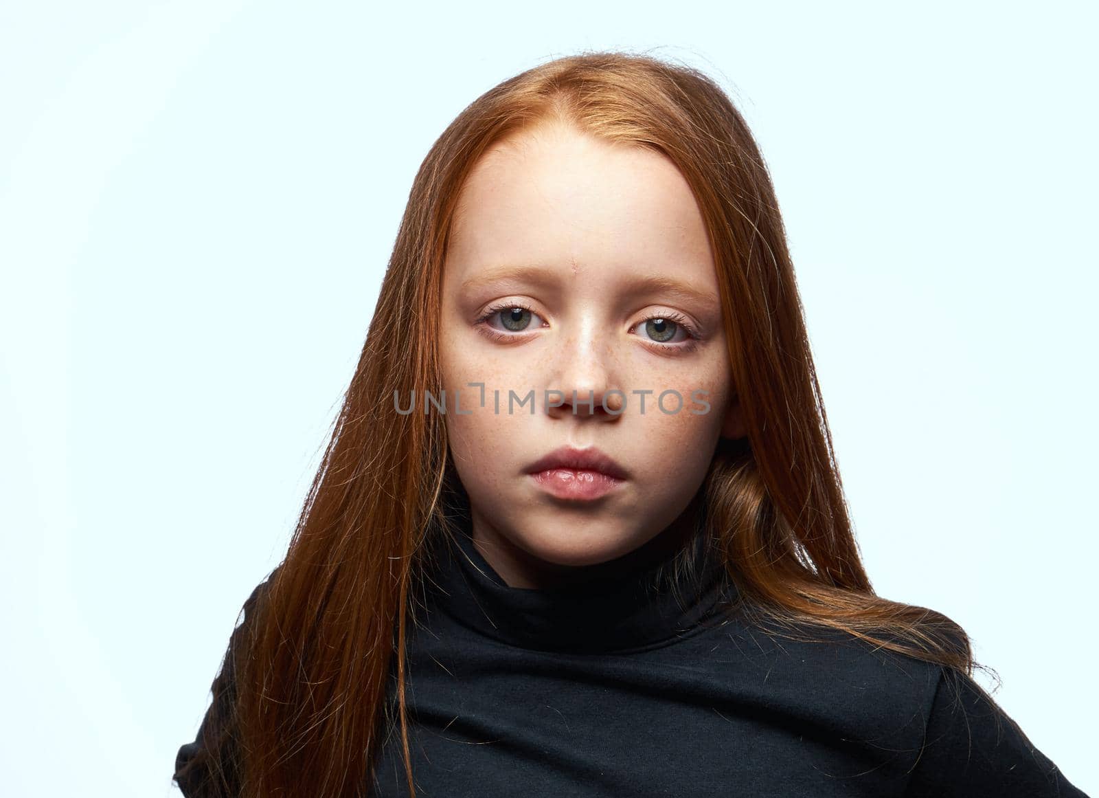 red-haired girl in a black sweater planning close-up. High quality photo