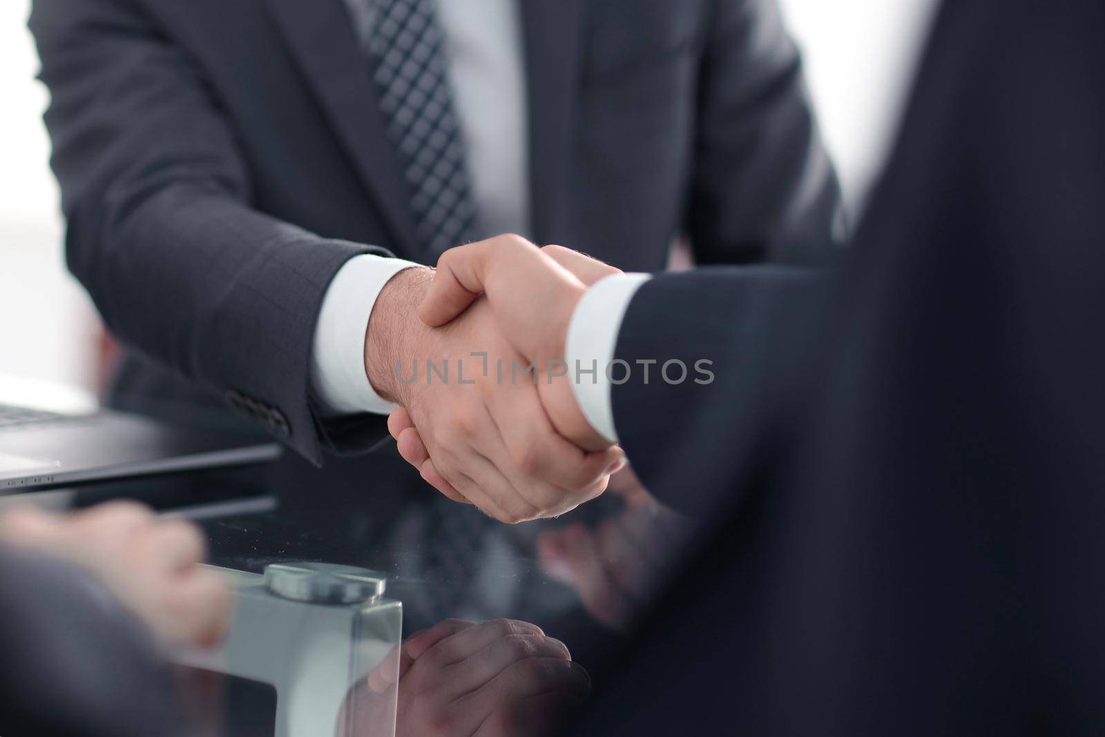 closeup.handshake of business partners after signing the contract.