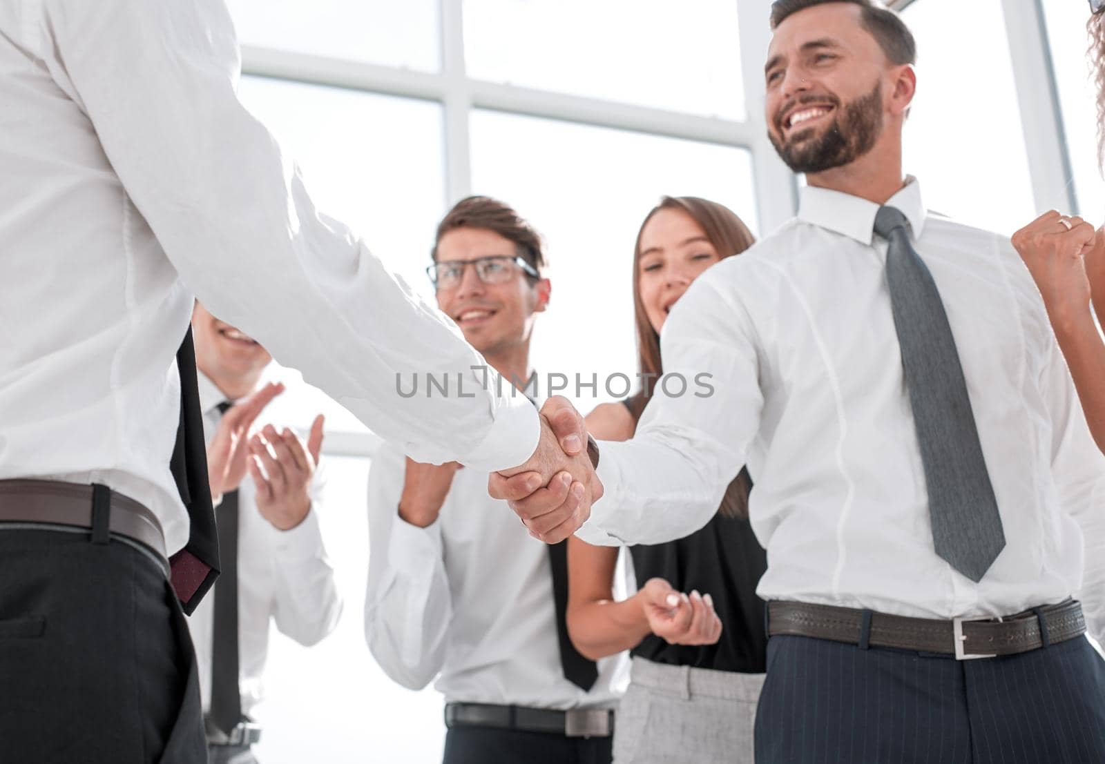 in the foreground.handshake business people in the office.business concept