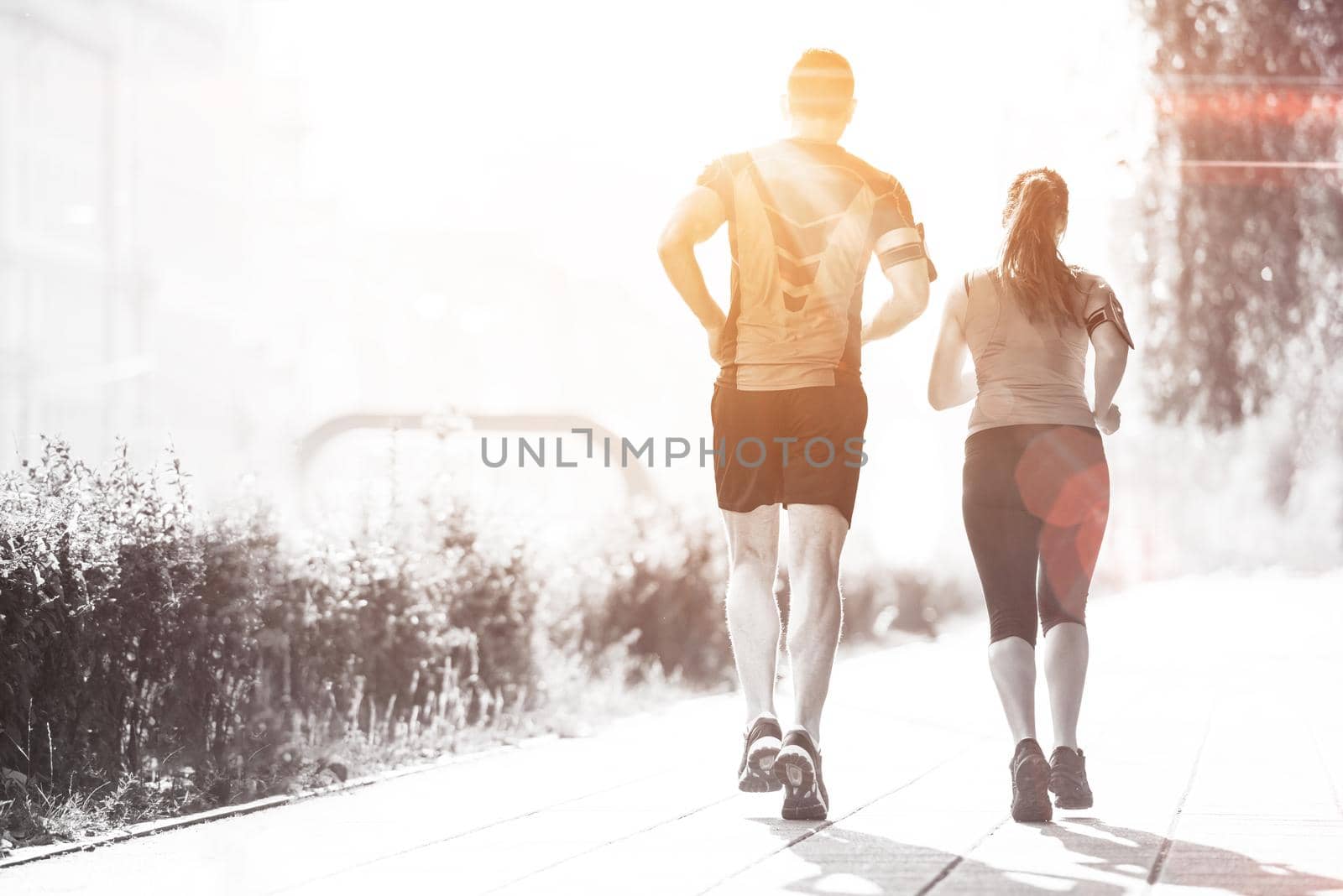 urban sports, healthy young couple jogging  in the city at sunny morning