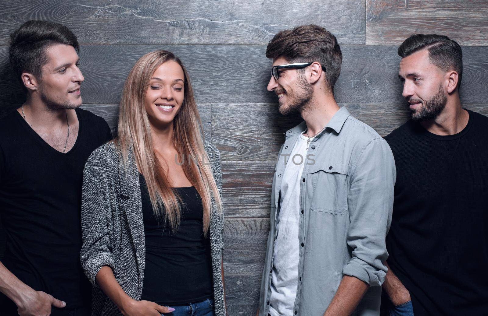 fashion group standing posing near gray wall by asdf