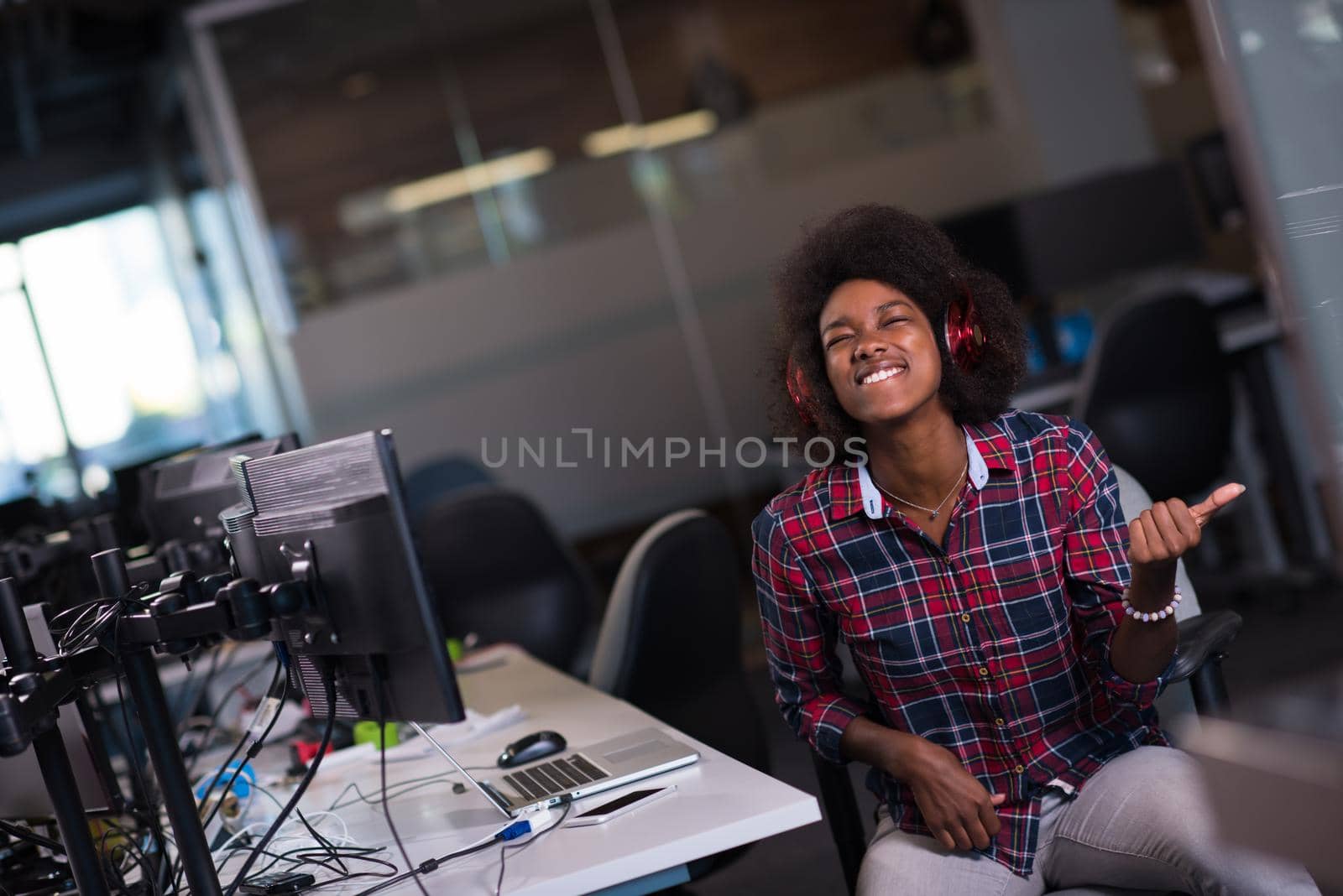 portrait of a young successful African-American woman in modern office by dotshock