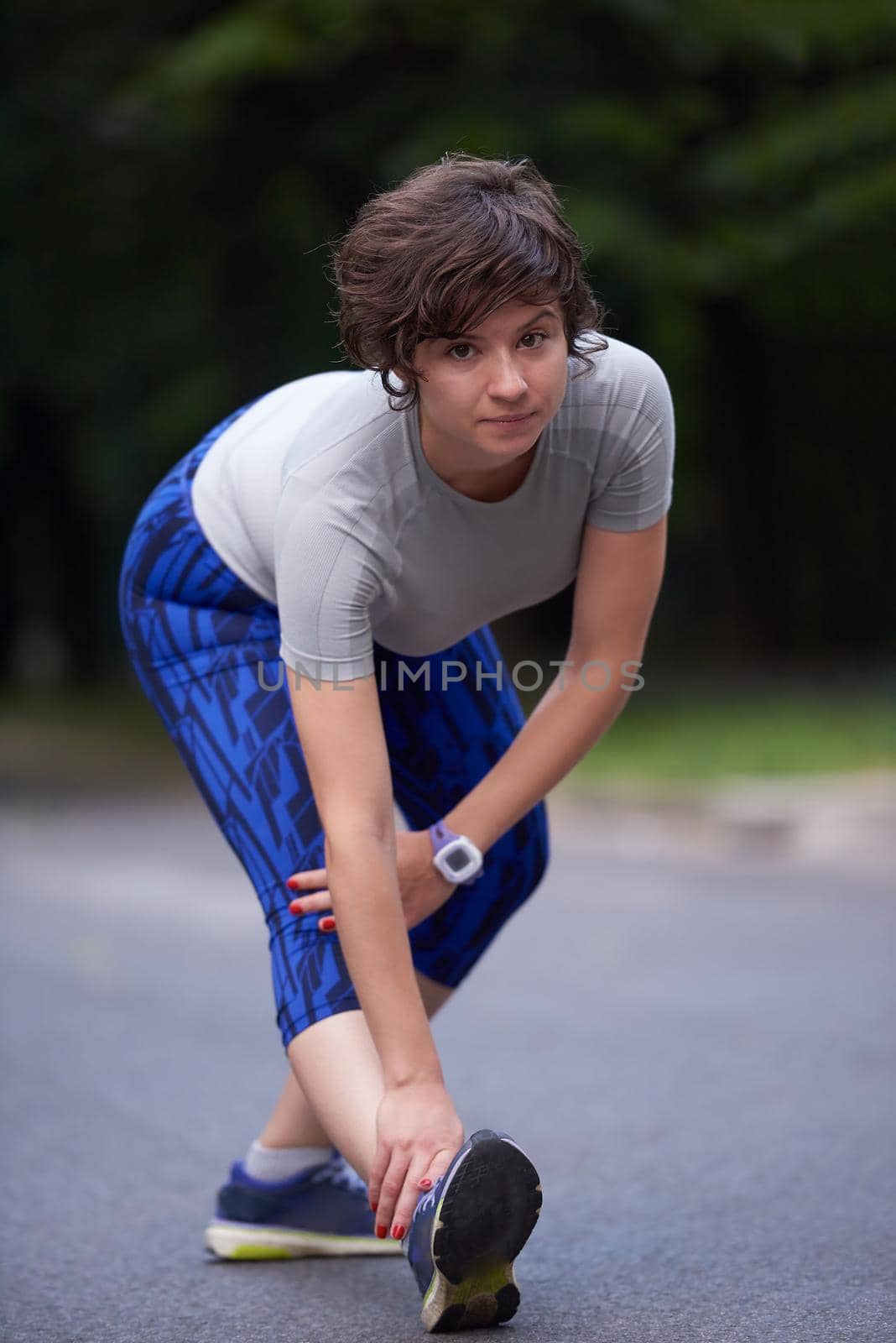 runner   woman warming up and stretching before morning jogging