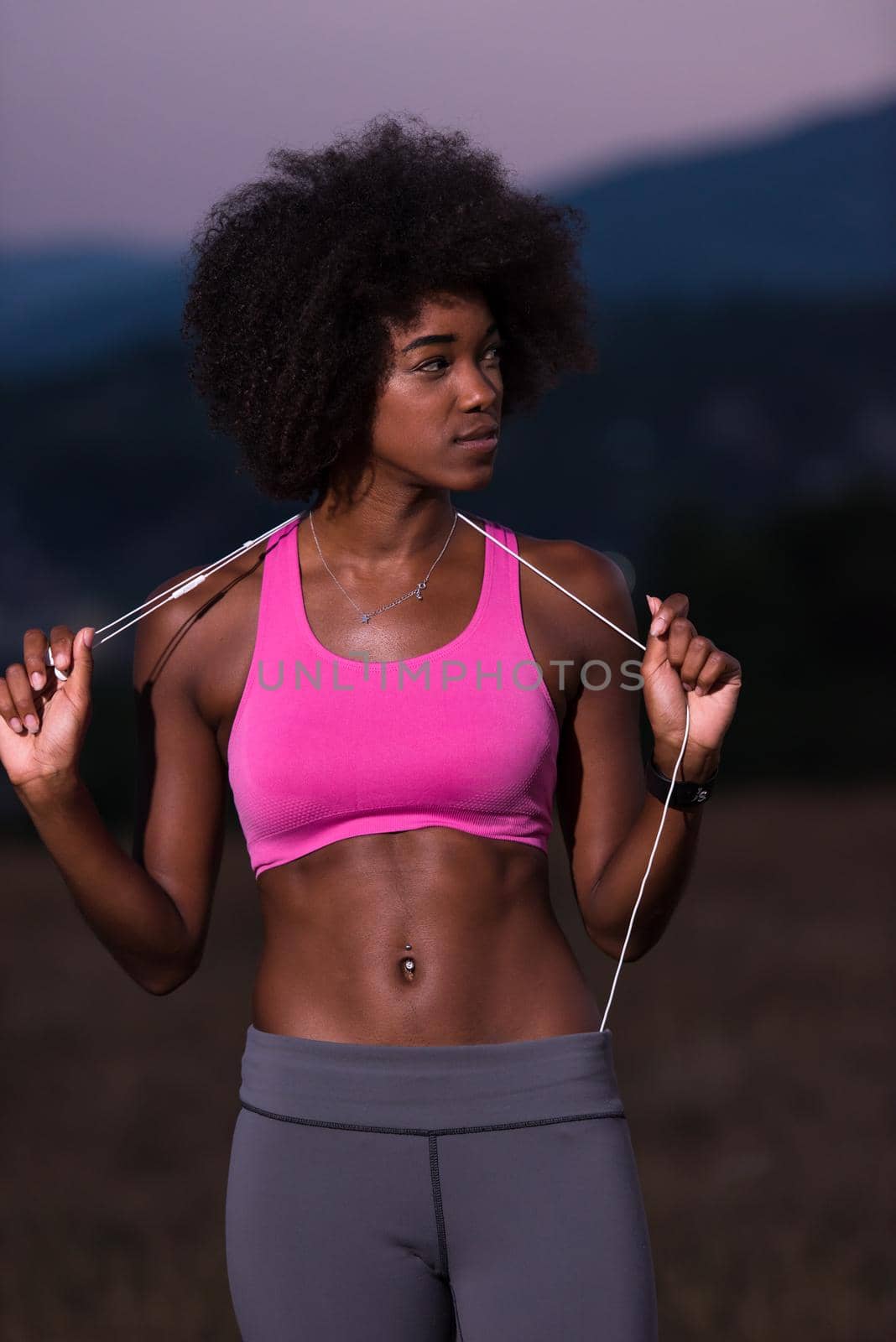 portrait of african american woman jogging in nature by dotshock