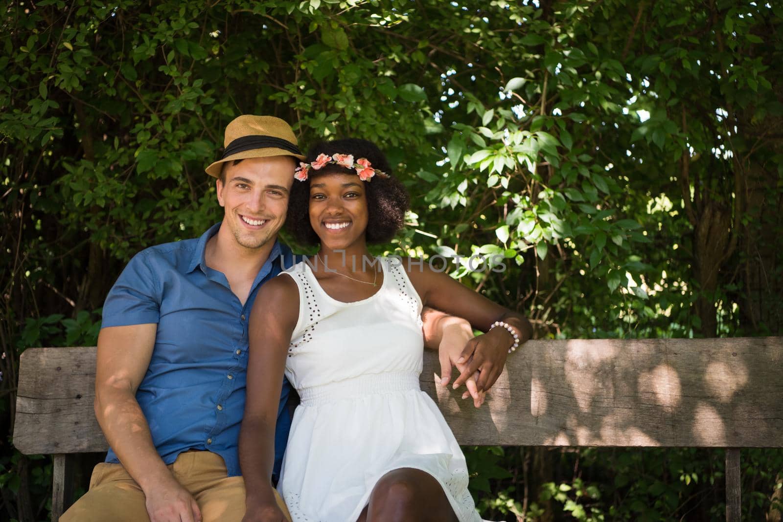 a young man and a beautiful African American girl enjoying a bike ride in nature on a sunny summer day