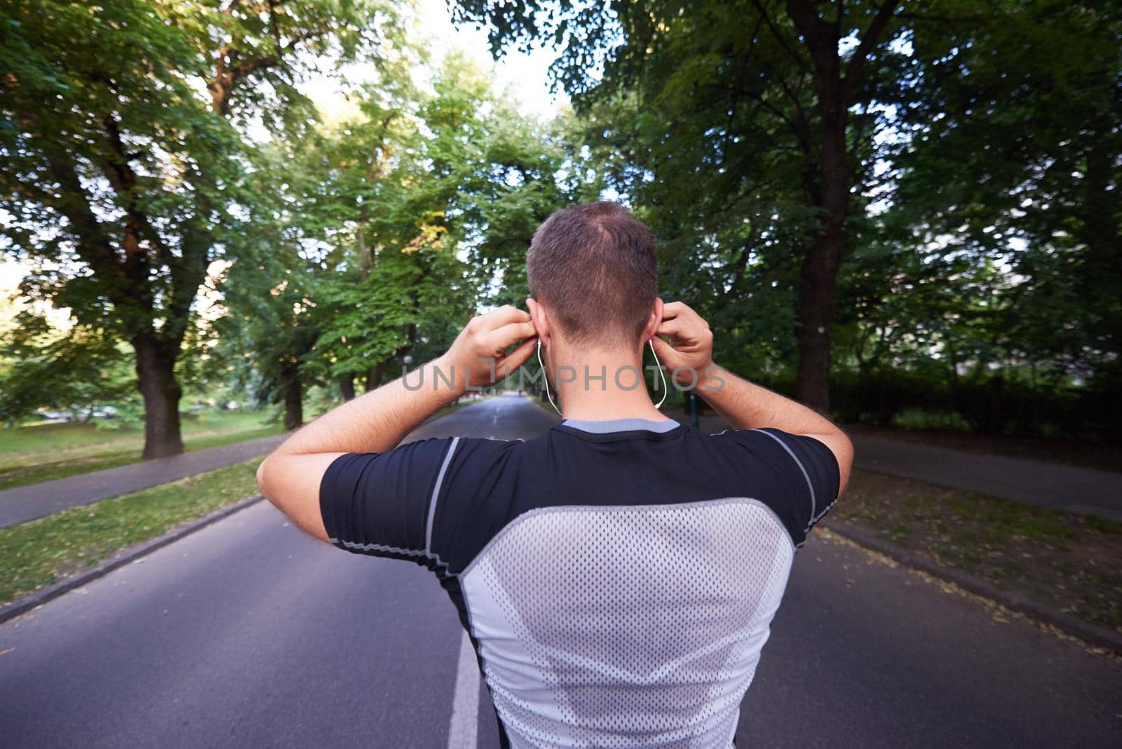 healthy athlete man jogging at morning on empty  roat in the city