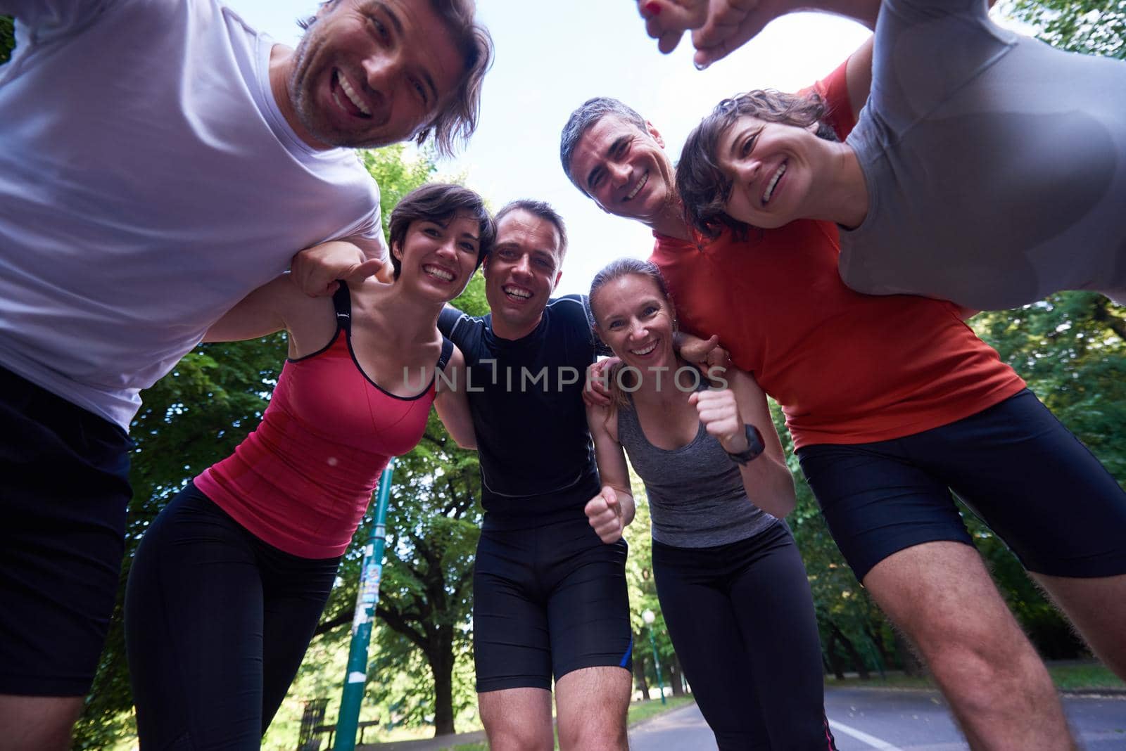 jogging people group, friends have fun,  hug and stack hands together after training