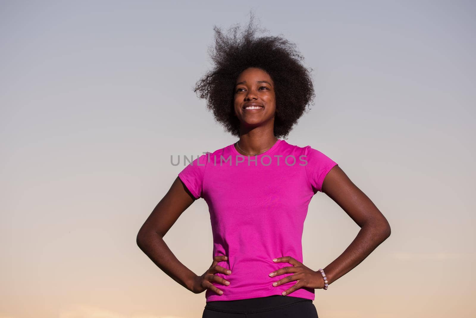 portrait of a young African American girl to run beautiful summer evening on city streets