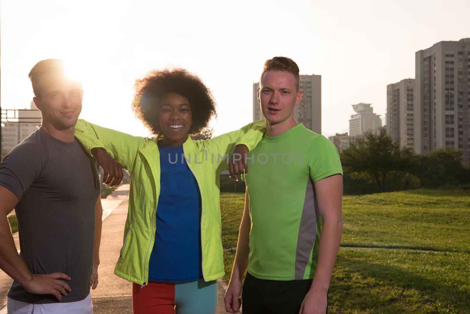 Portrait of multi-ethnic group of young people on the jogging beautiful summer evening as the sun sets over the city