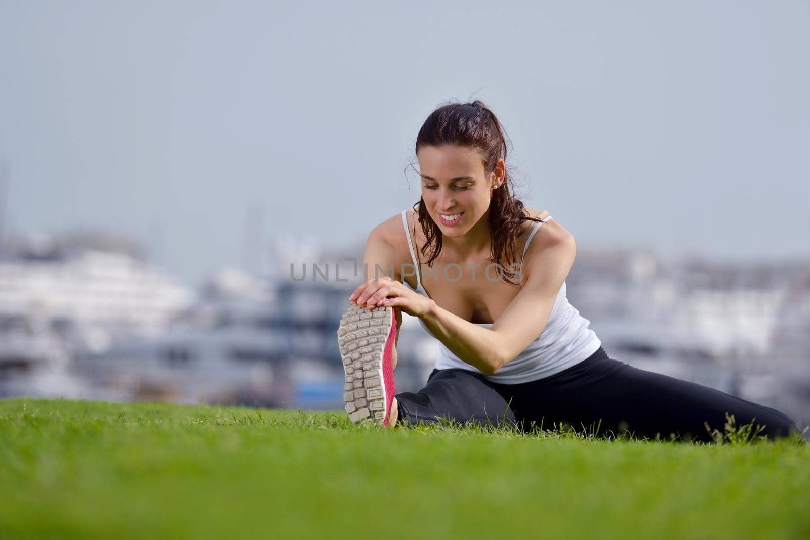 Young beautiful  woman jogging and running  on morning at  park in the city. Woman in sport outdoors health and fitness concept