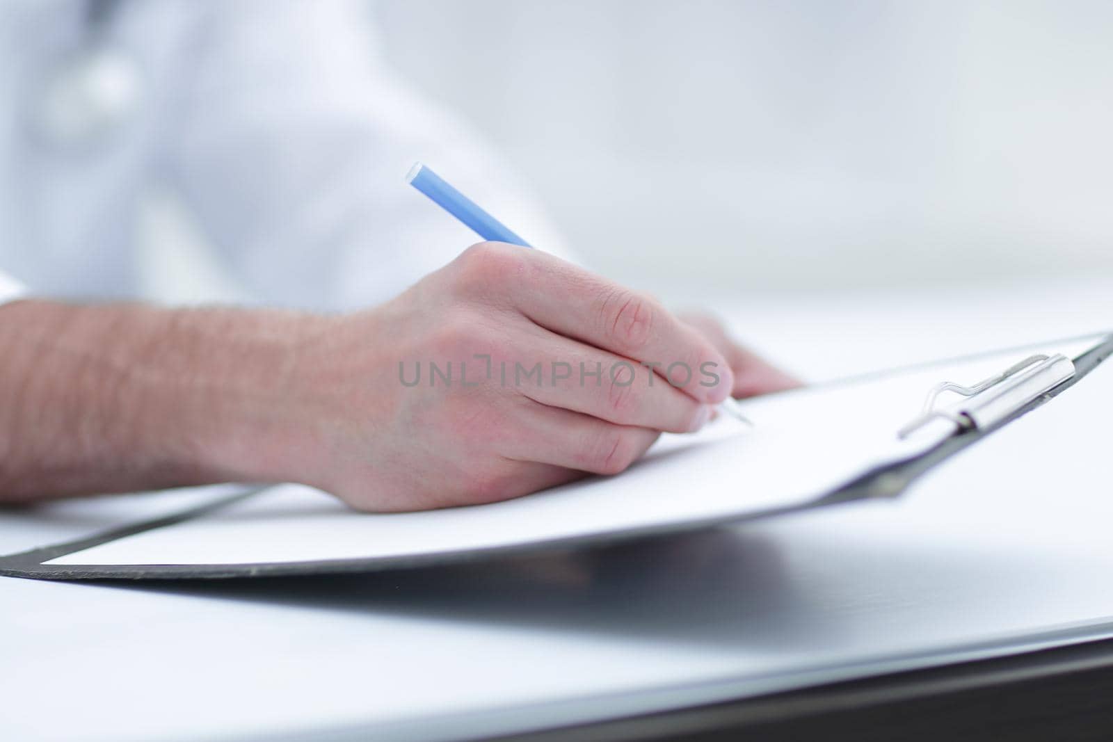 doctor writing out the prescription.close-up by asdf