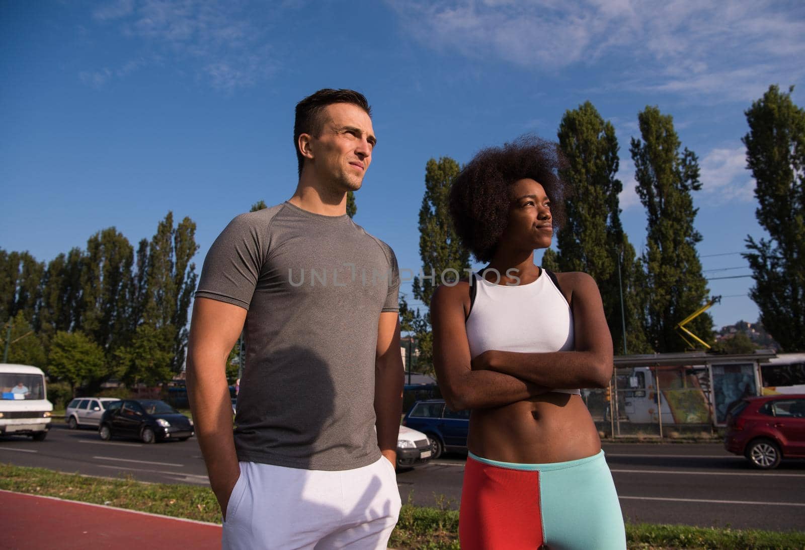 portrait of a young African American beautiful woman and a young man jogging in the city