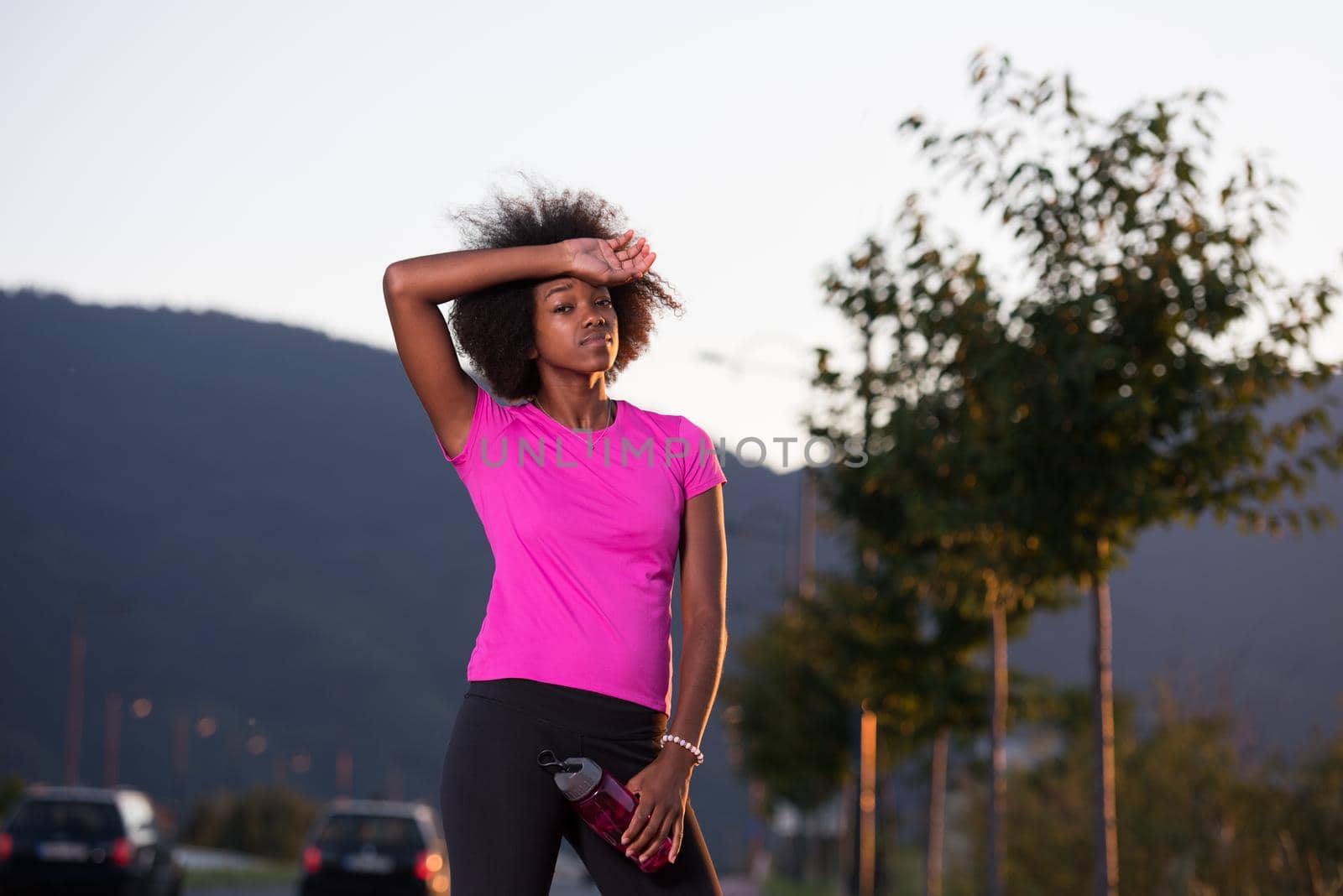 portrait of a young African American girl to run beautiful summer evening on city streets