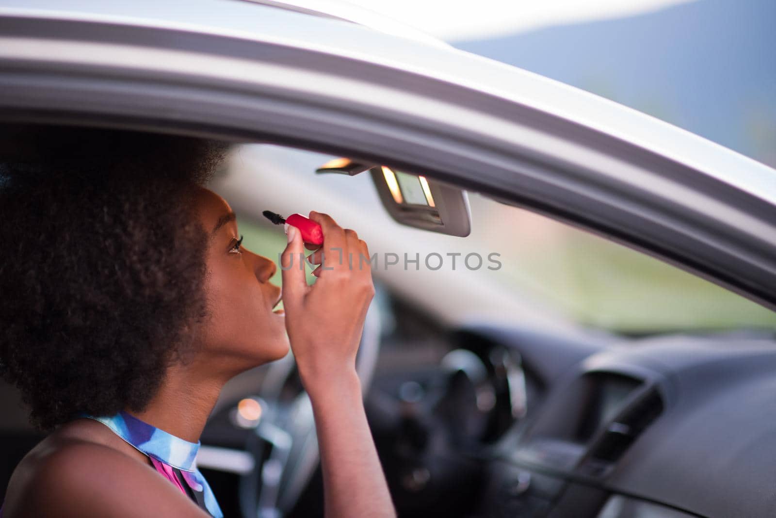 a young African-American woman makeup in the car by dotshock
