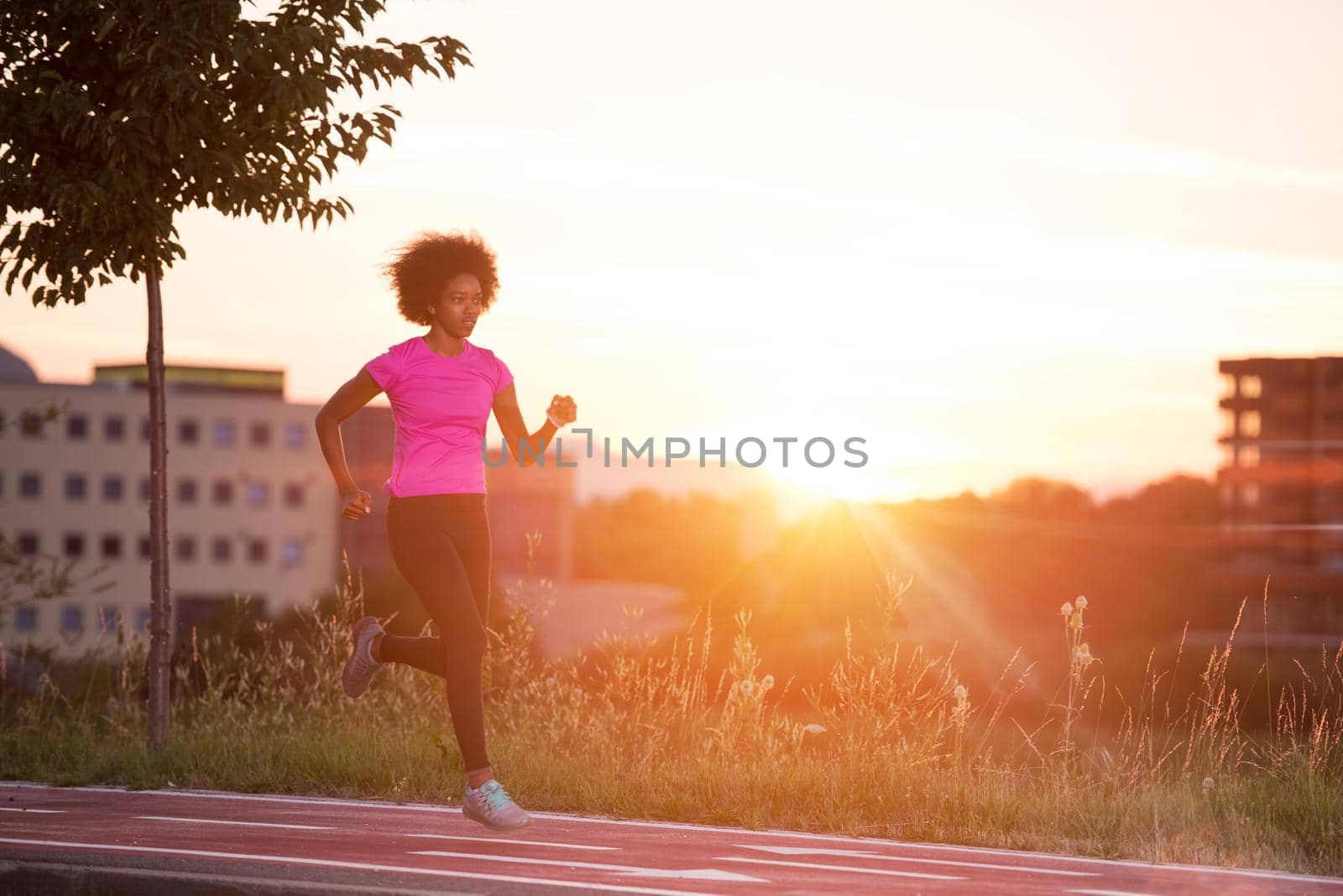 a young African American woman jogging outdoors by dotshock