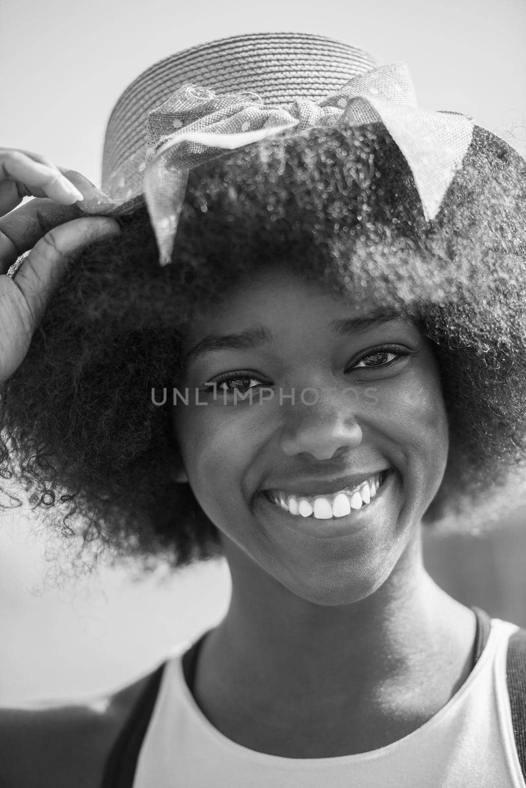 Close up portrait of a beautiful young african american woman smiling and looking up on a beautiful sunny day