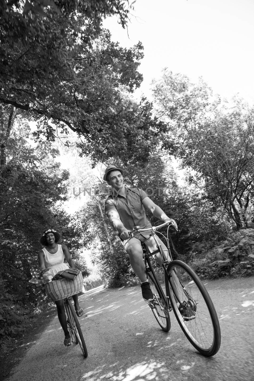 Young multiethnic couple having a bike ride in nature by dotshock