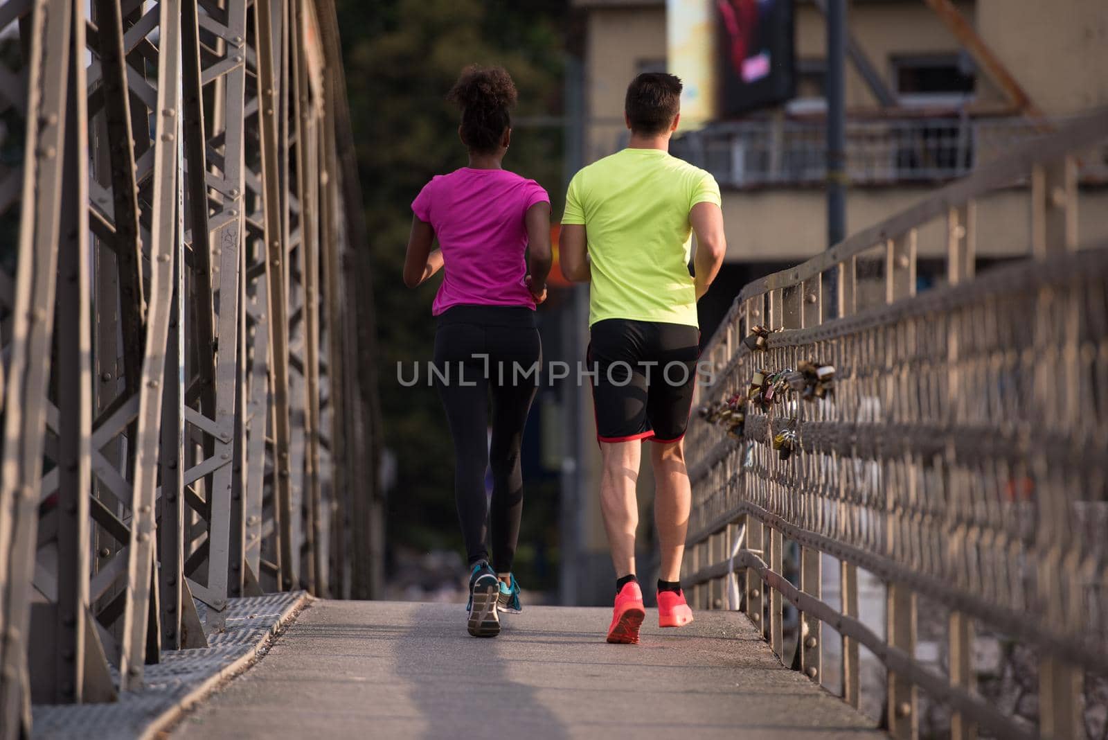 multiethnic couple jogging in the city by dotshock