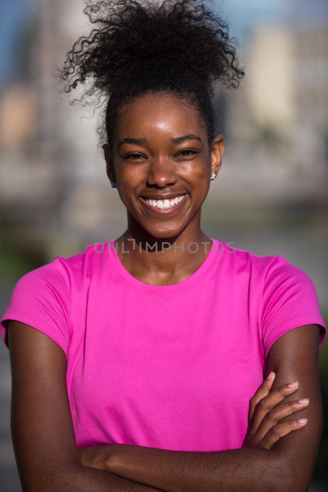 Portrait of sporty young african american woman running outdoors by dotshock