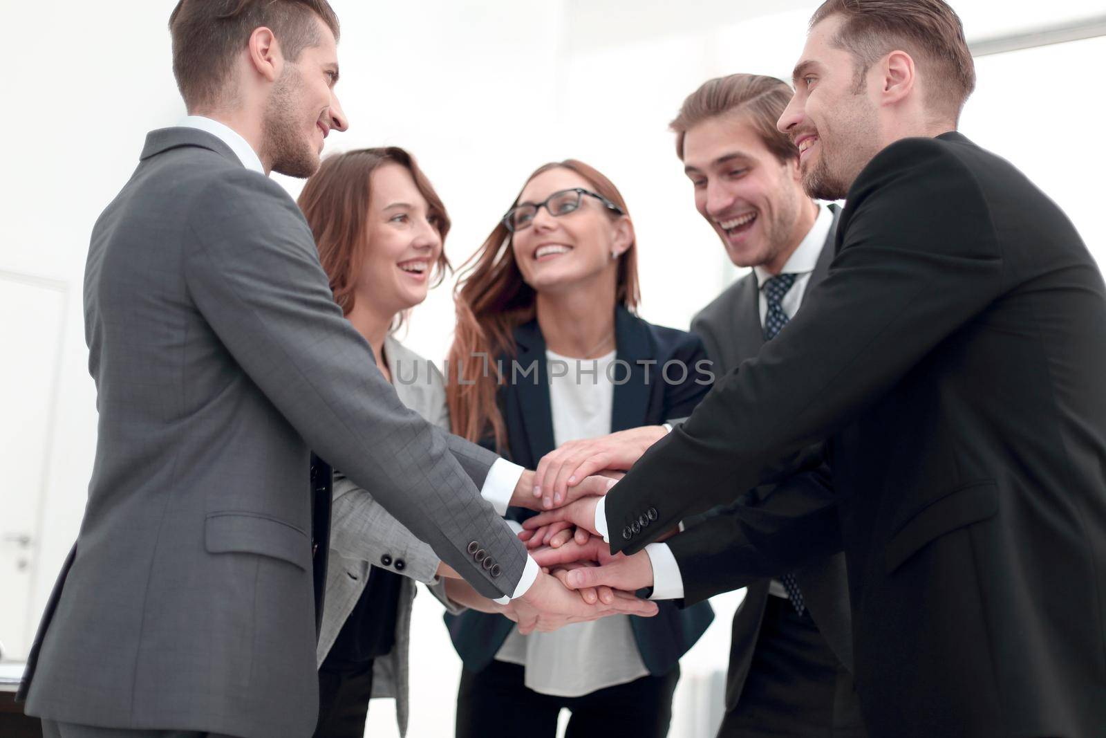 Close-up of people holding hands together while by asdf