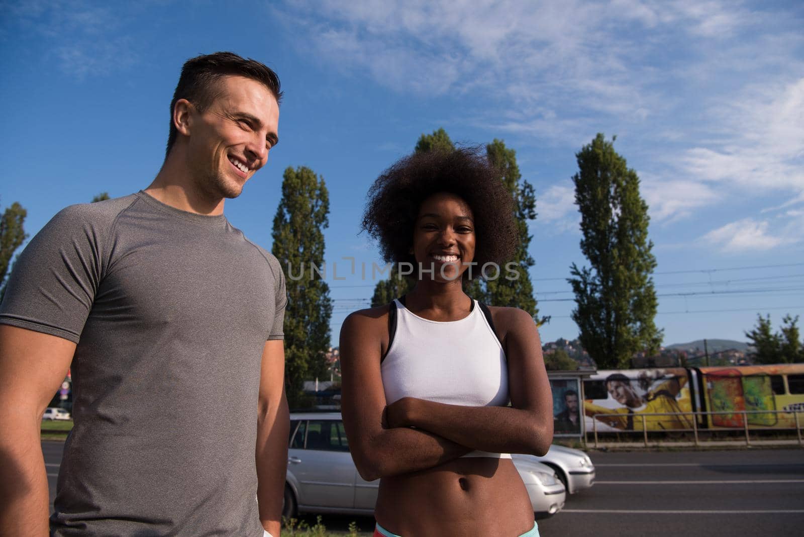 portrait of a young African American beautiful woman and a young man jogging in the city