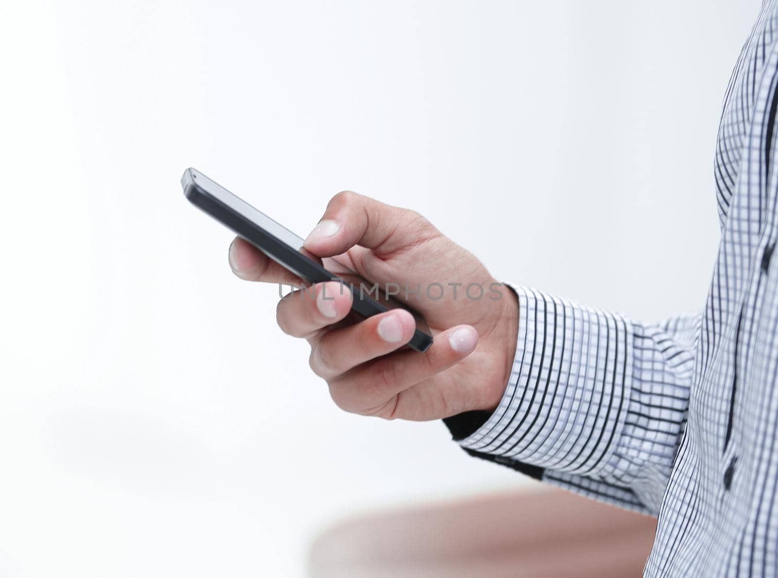 closeup.a man holds a smartphone.photos on blurred background
