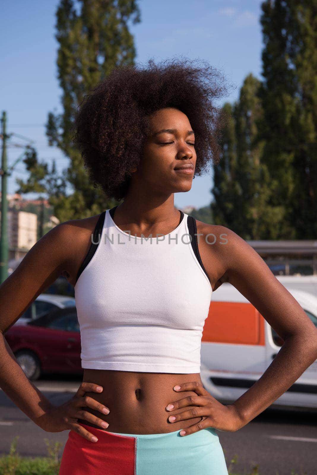 Portrait of sporty young african american woman running outdoors by dotshock