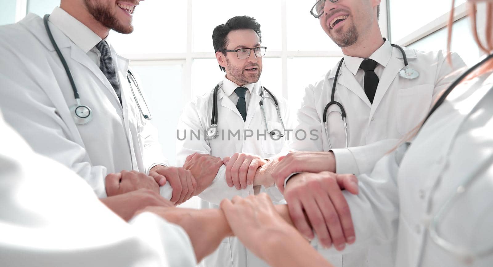 close up.a group of doctors standing in a circle by asdf