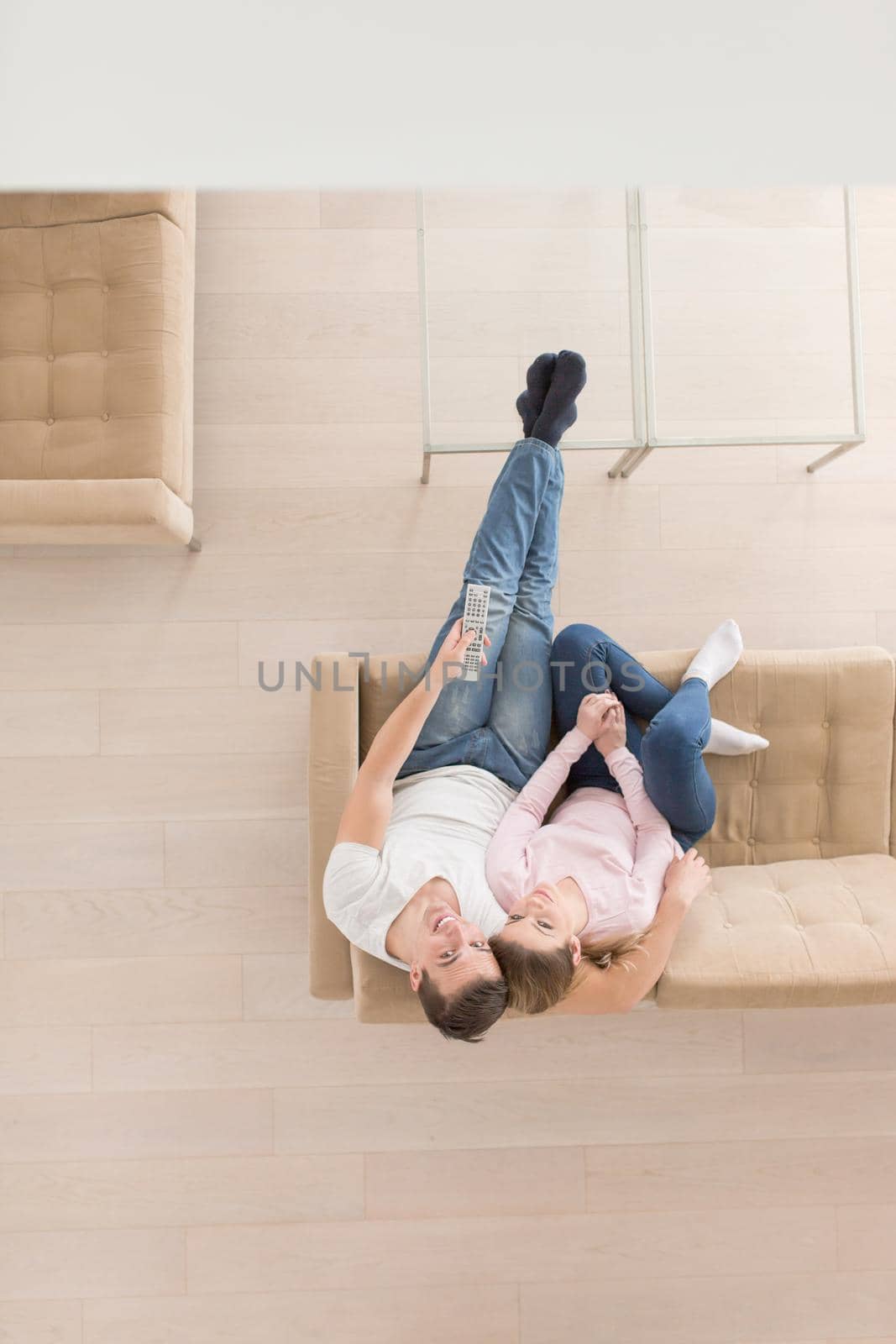 top view of Young couple on the sofa watching television together at home