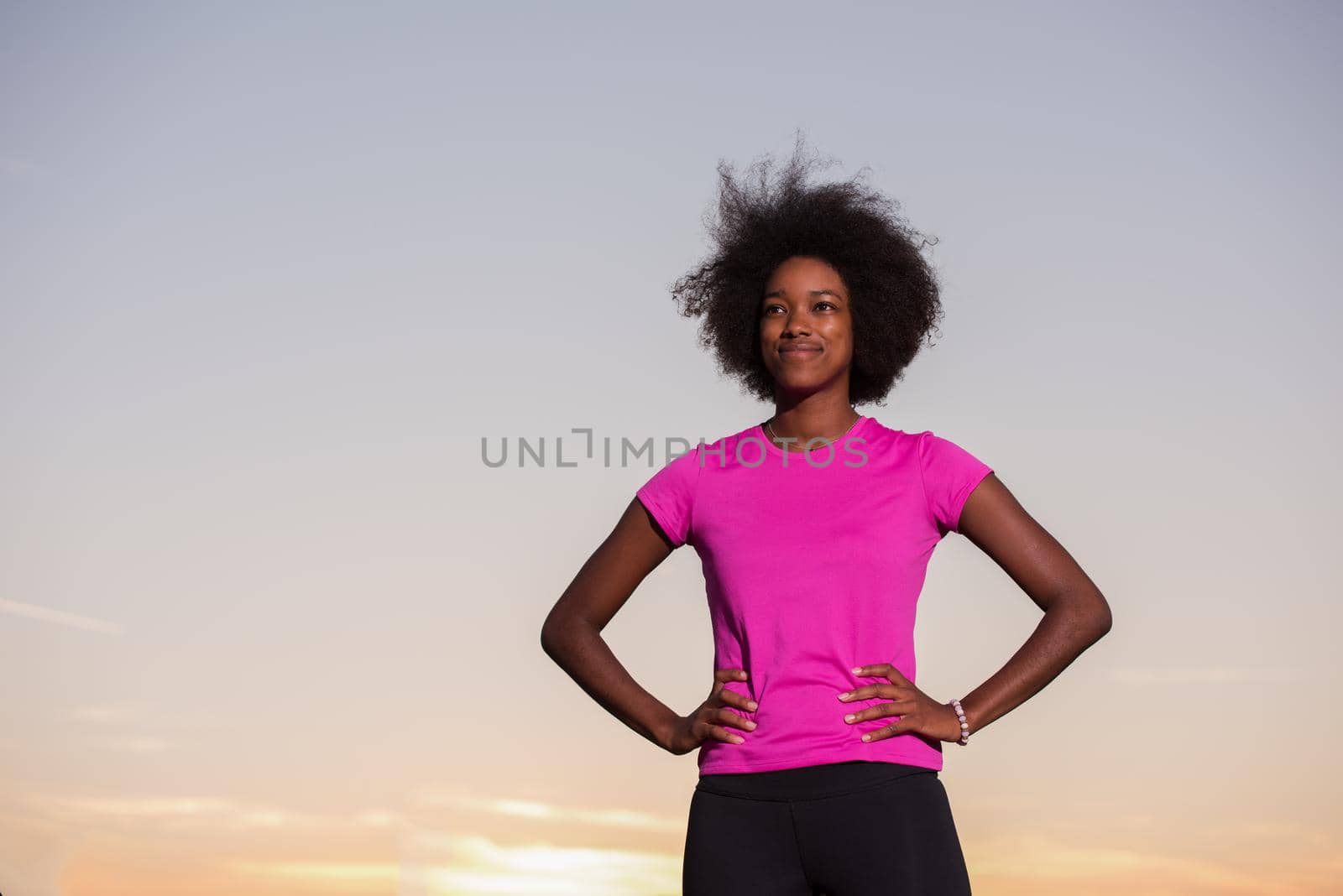 portrait of a young African American girl to run beautiful summer evening on city streets