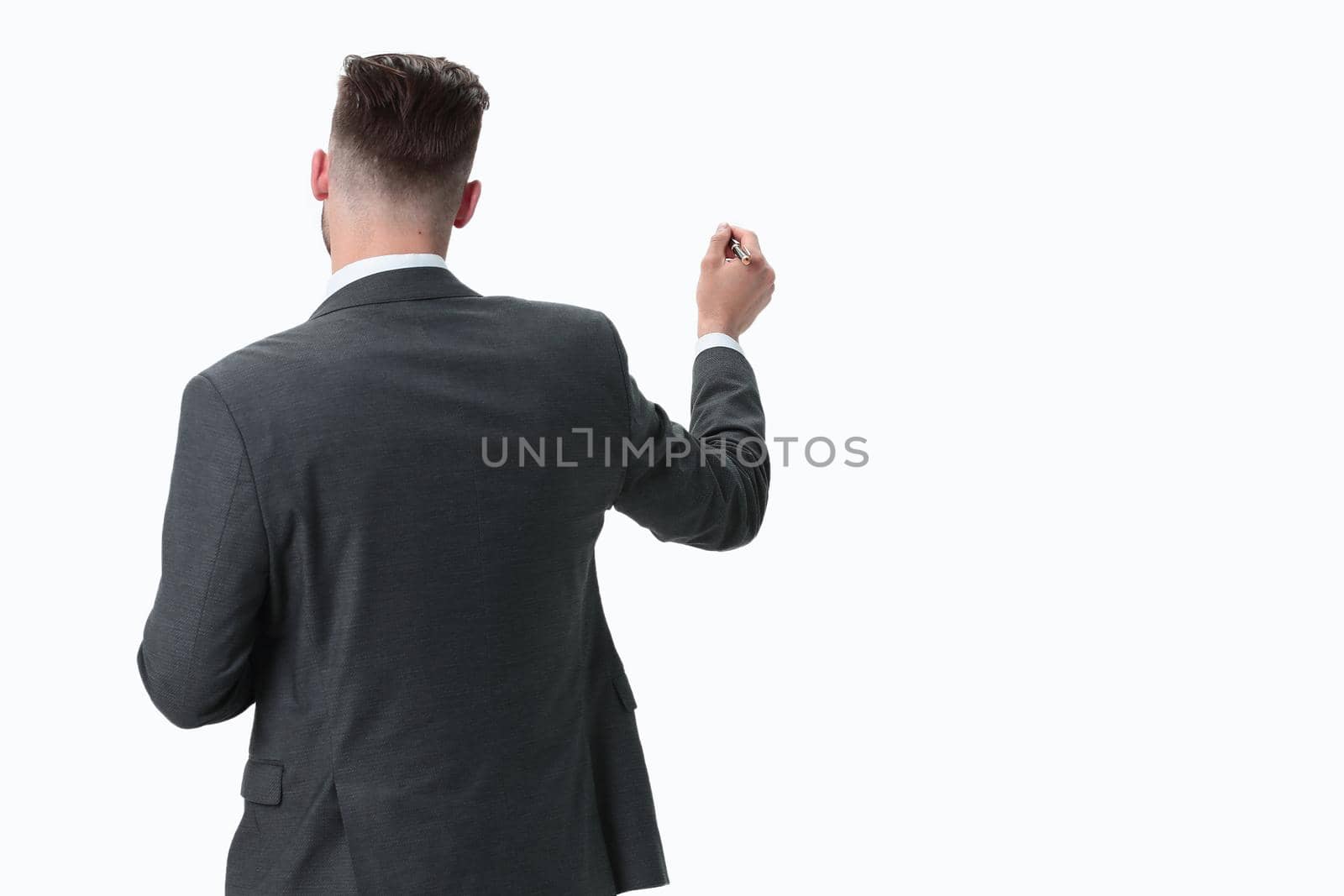 rear view.businessman writing on an invisible Board.photo with copy space