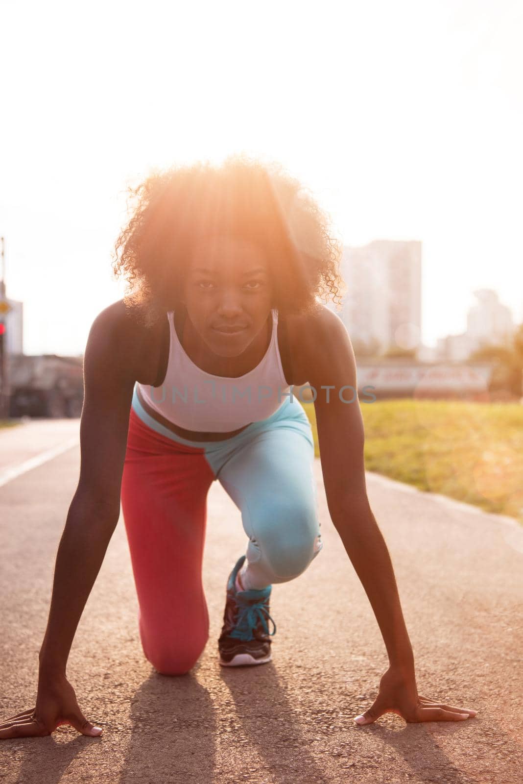 portrait of a young African American girl to run beautiful summer morning on city streets