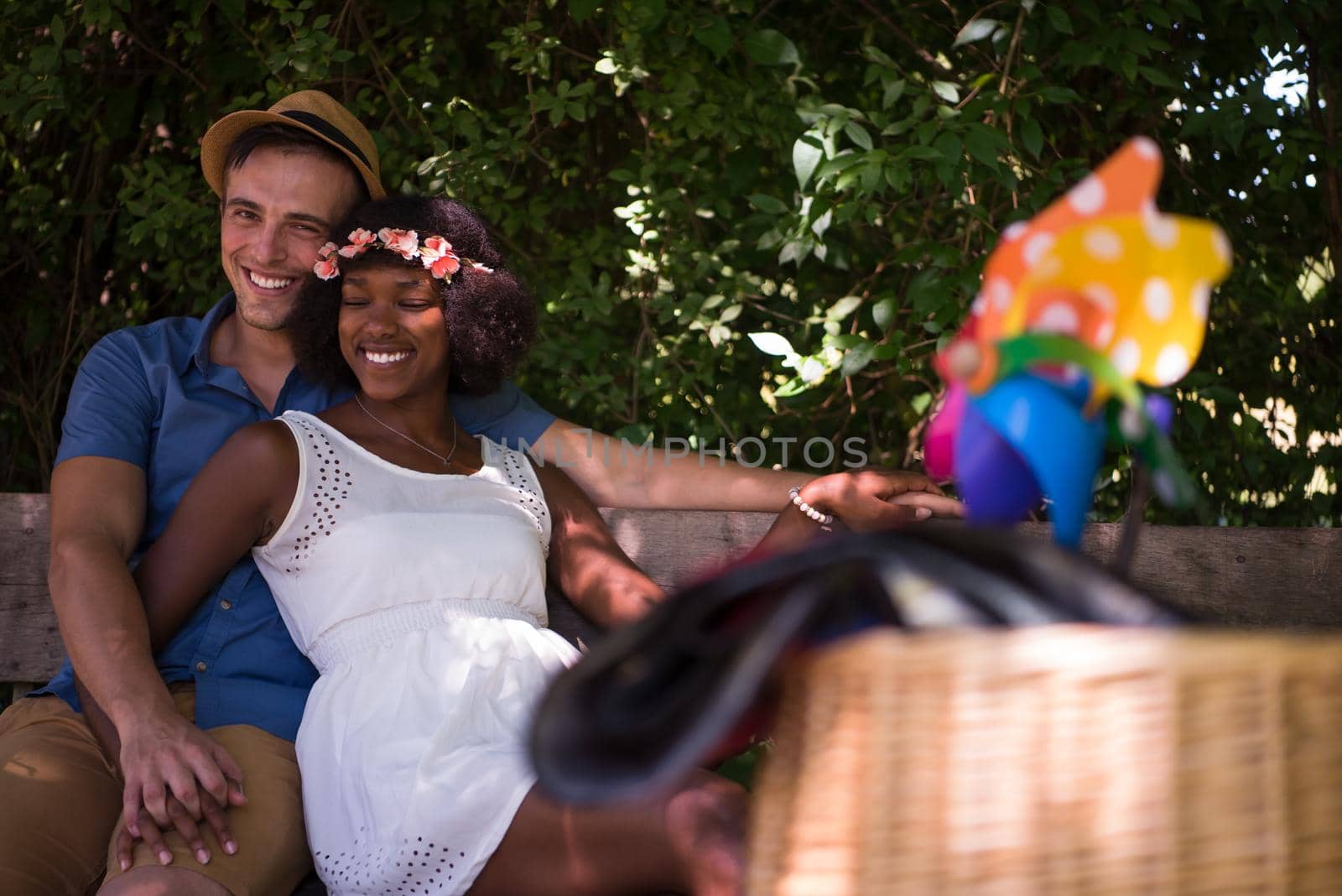 a young man and a beautiful African American girl enjoying a bike ride in nature on a sunny summer day