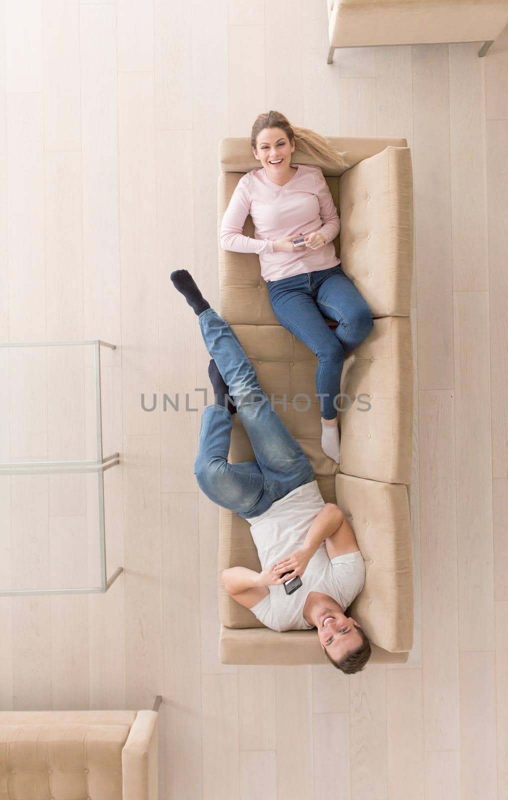 top view of Young couple on the sofa watching television together at home