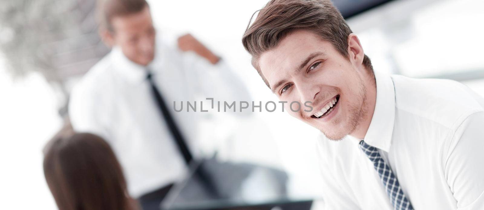 young employee of the company on the background of the office