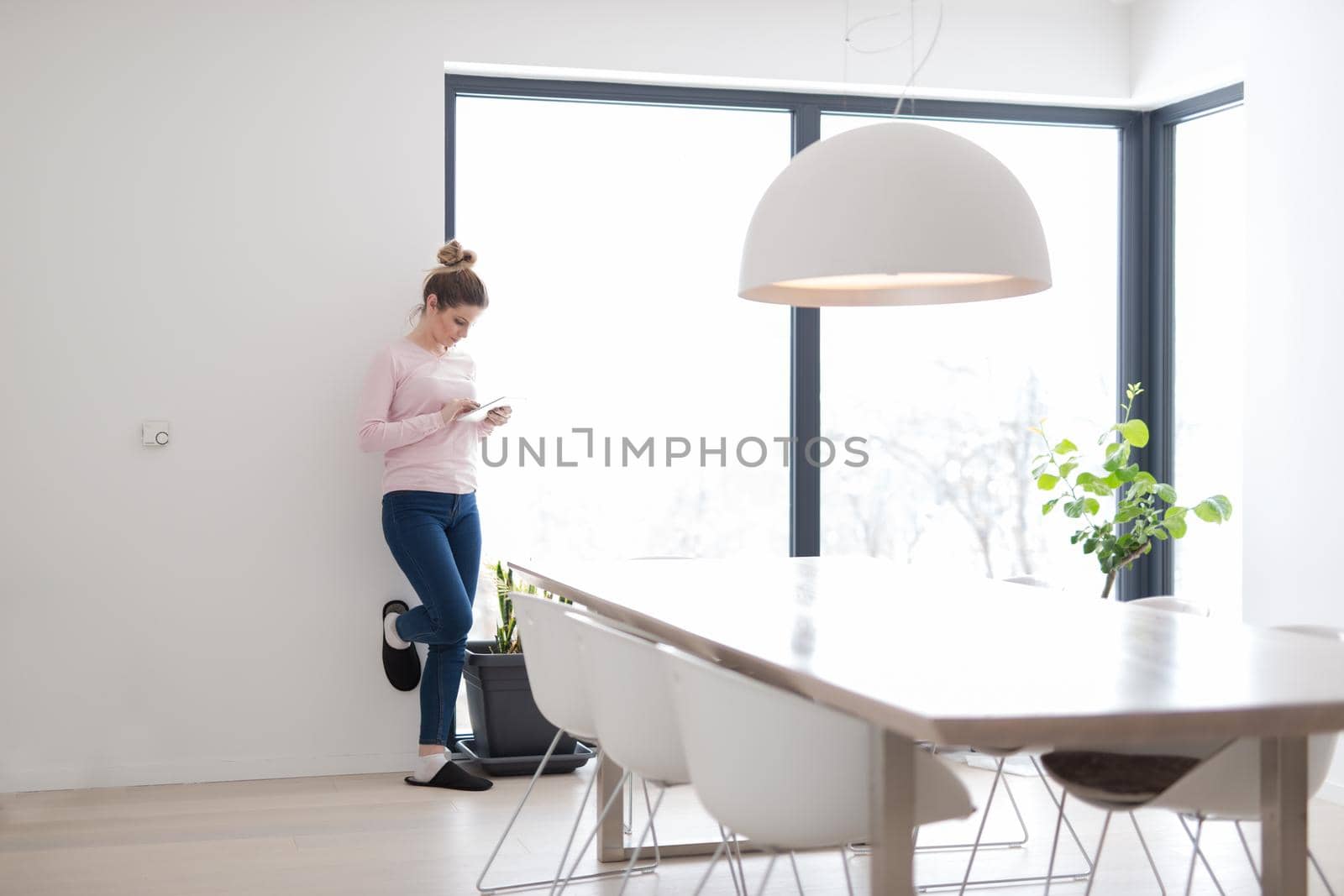 beautiful young woman using tablet computer on the floor at home