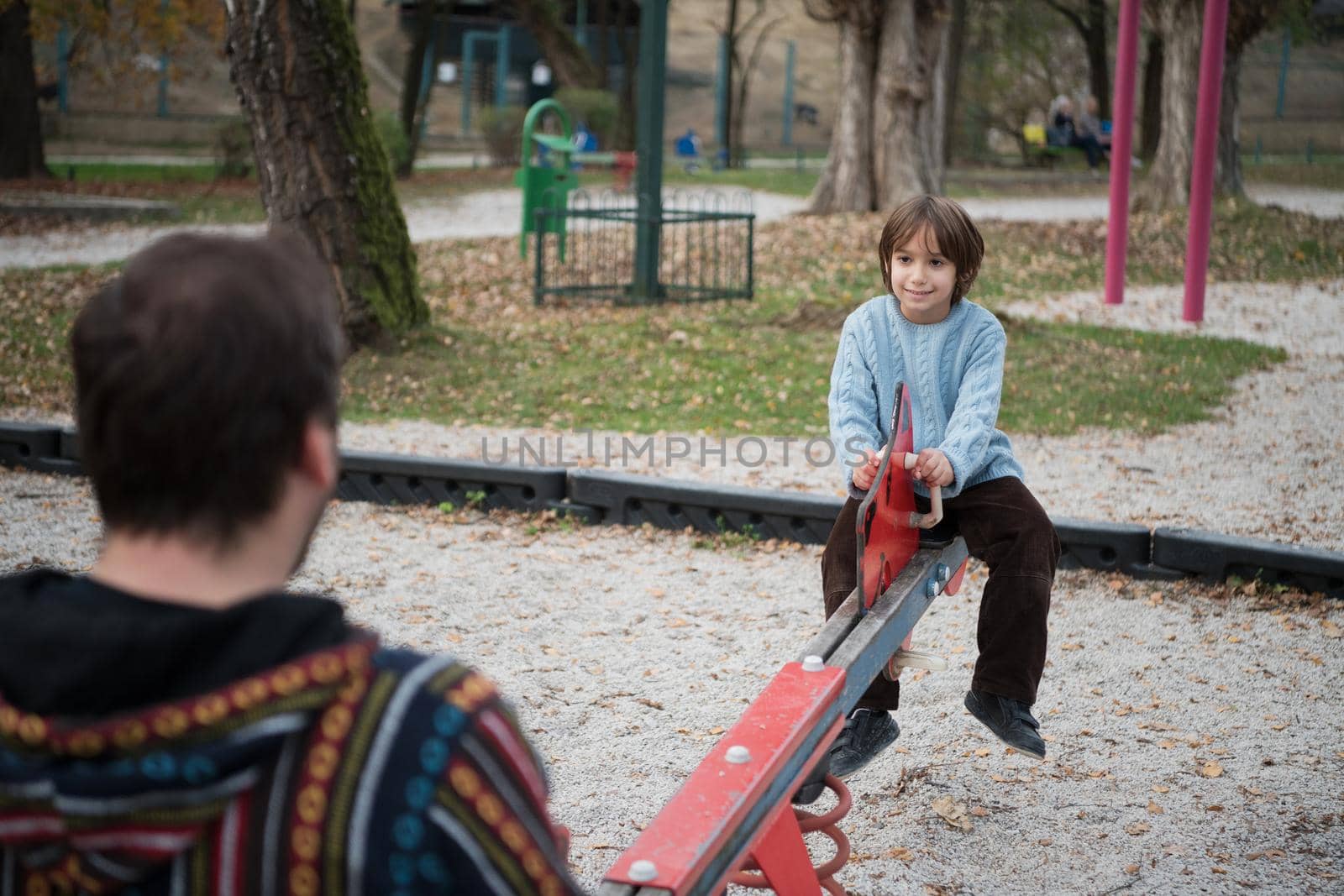 father and  child having fun together  in park playground happy family concept