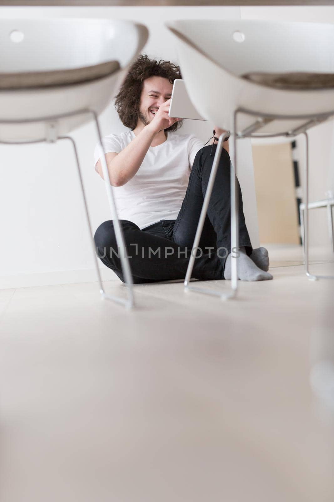 young man using a tablet at home by dotshock