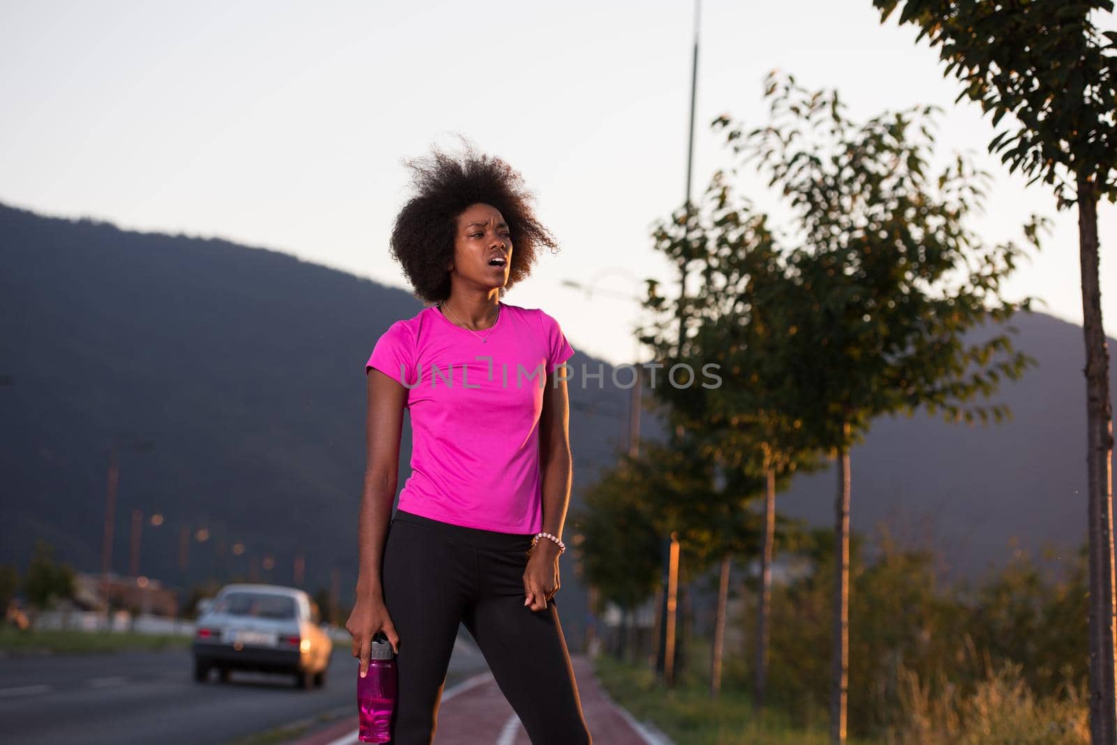 portrait of a young African American girl to run beautiful summer evening on city streets