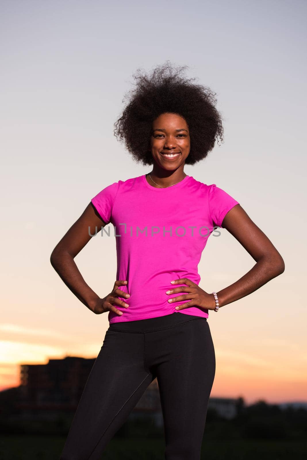 portrait of a young African American girl to run beautiful summer evening on city streets