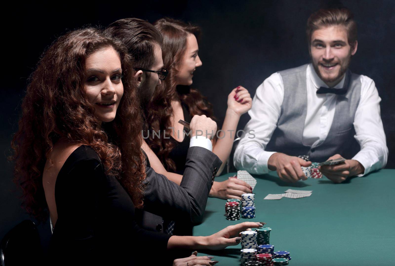 closeup.poker players sitting at a casino table by asdf