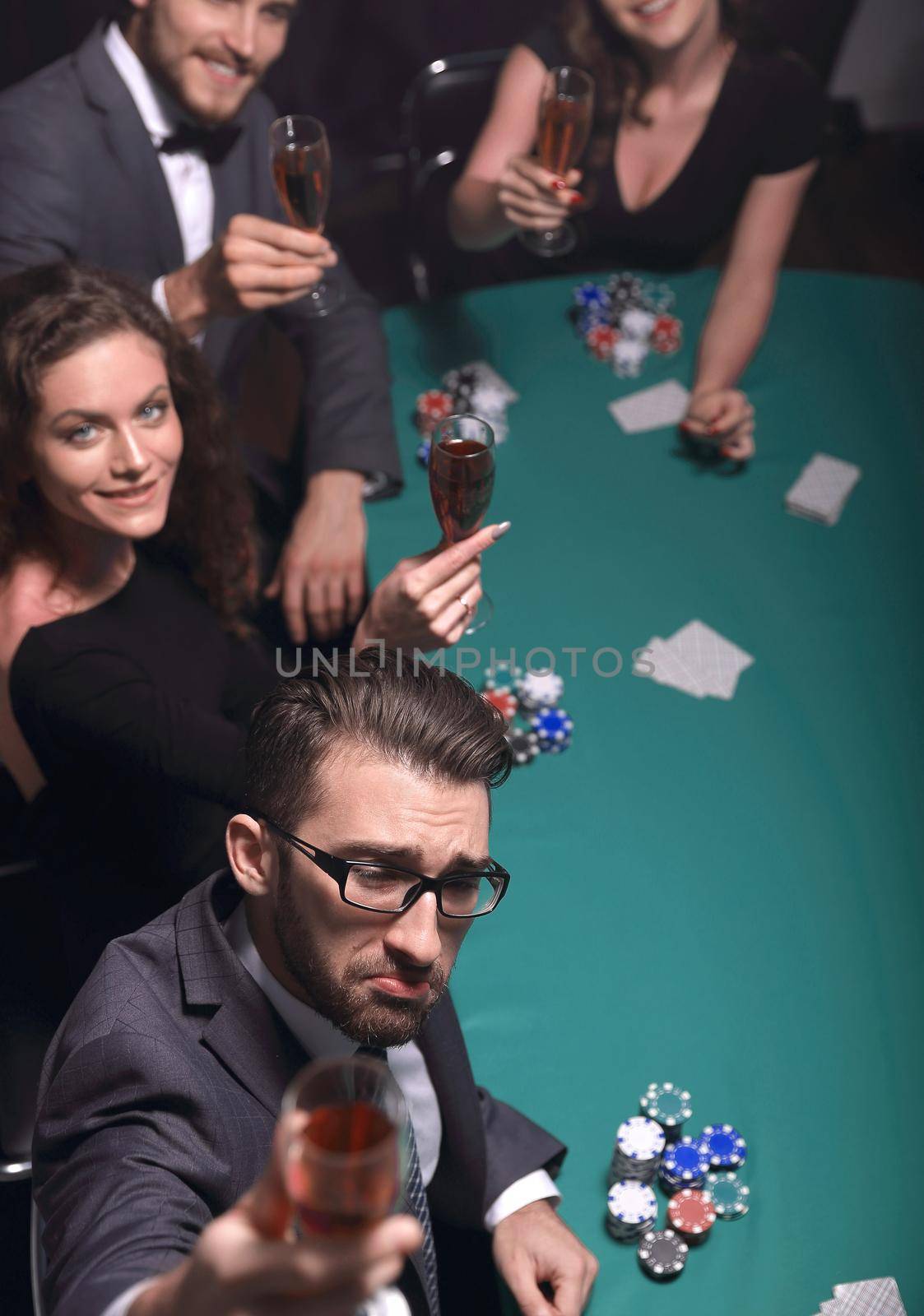 Group of young rich people is playing poker in the casino.photo with copy space