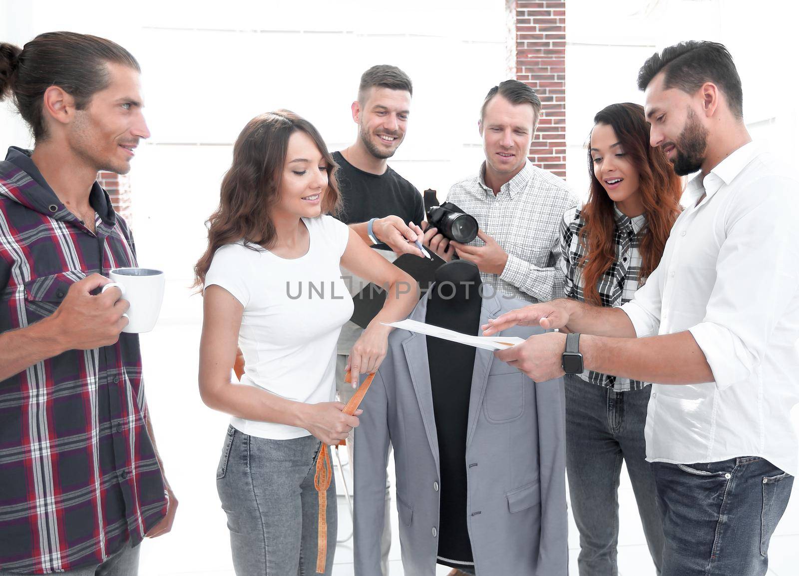 group of designers working with new models of men's clothing. photo with copy space