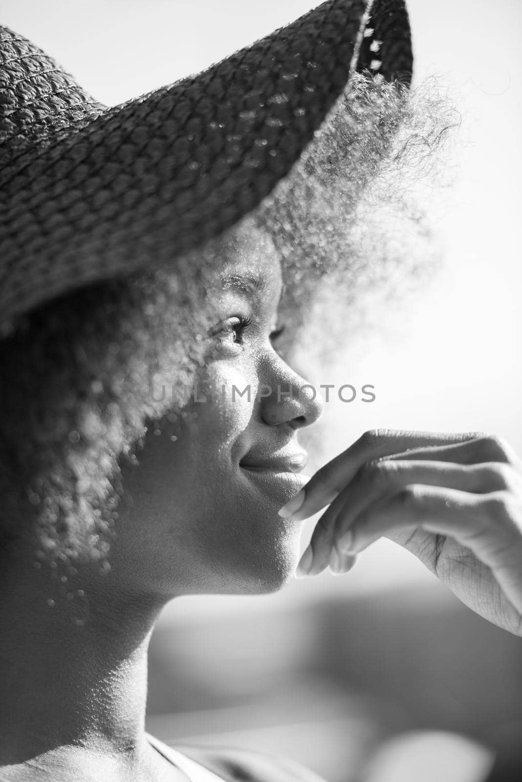 Close up portrait of a beautiful young african american woman smiling and looking up on a beautiful sunny day