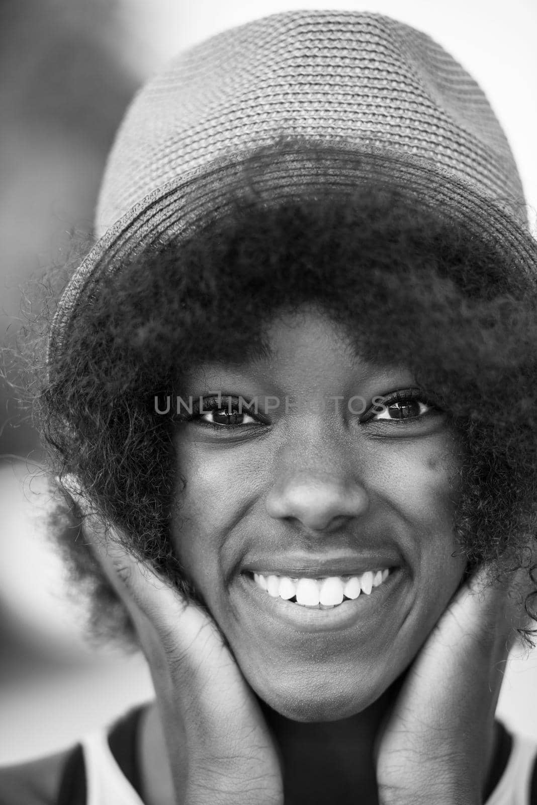 Close up portrait of a beautiful young african american woman smiling and looking up on a beautiful sunny day