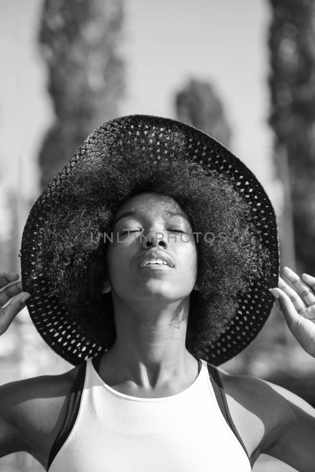 Close up portrait of a beautiful young african american woman smiling and looking up on a beautiful sunny day