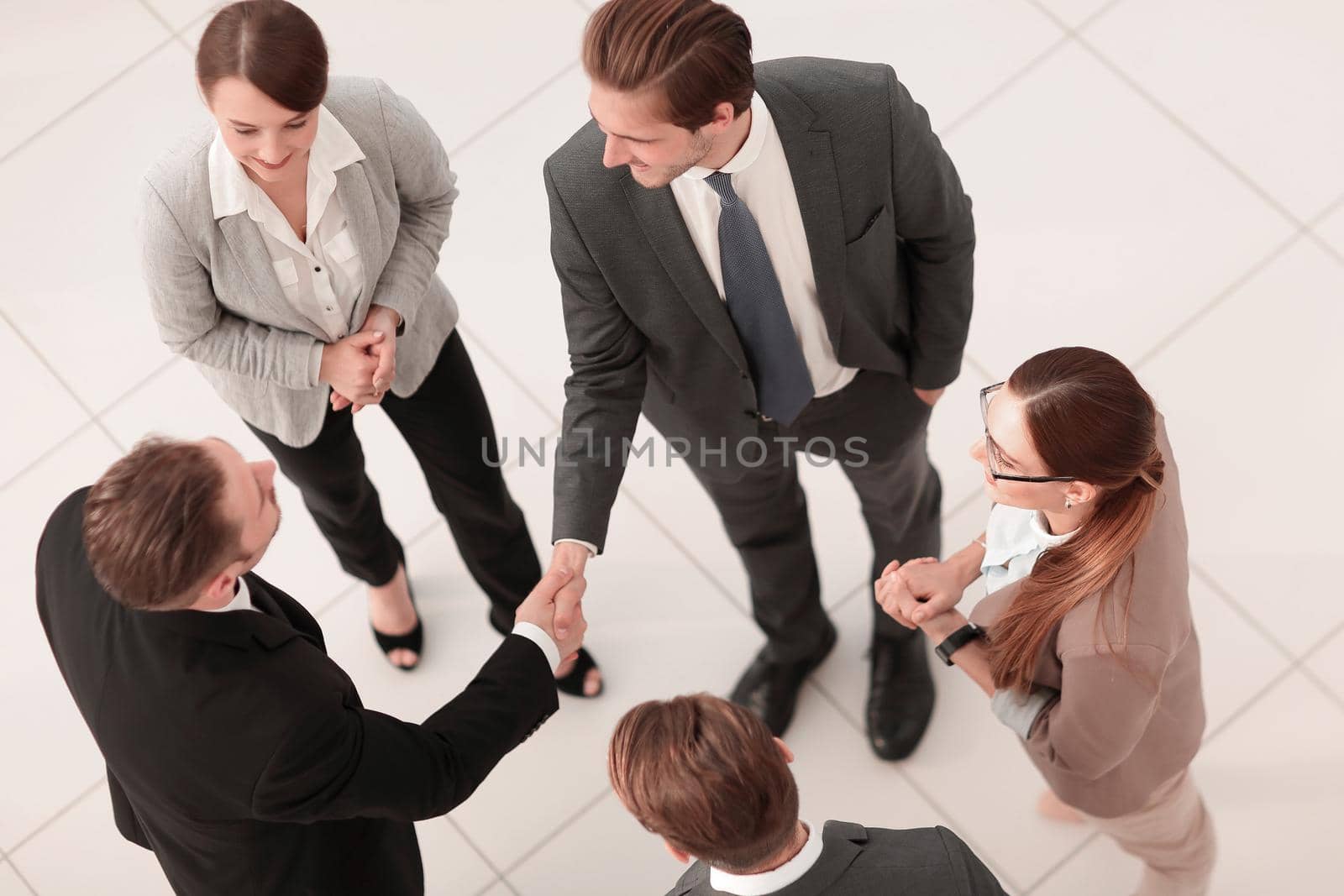 top view.handshake business partners before a business meeting by asdf