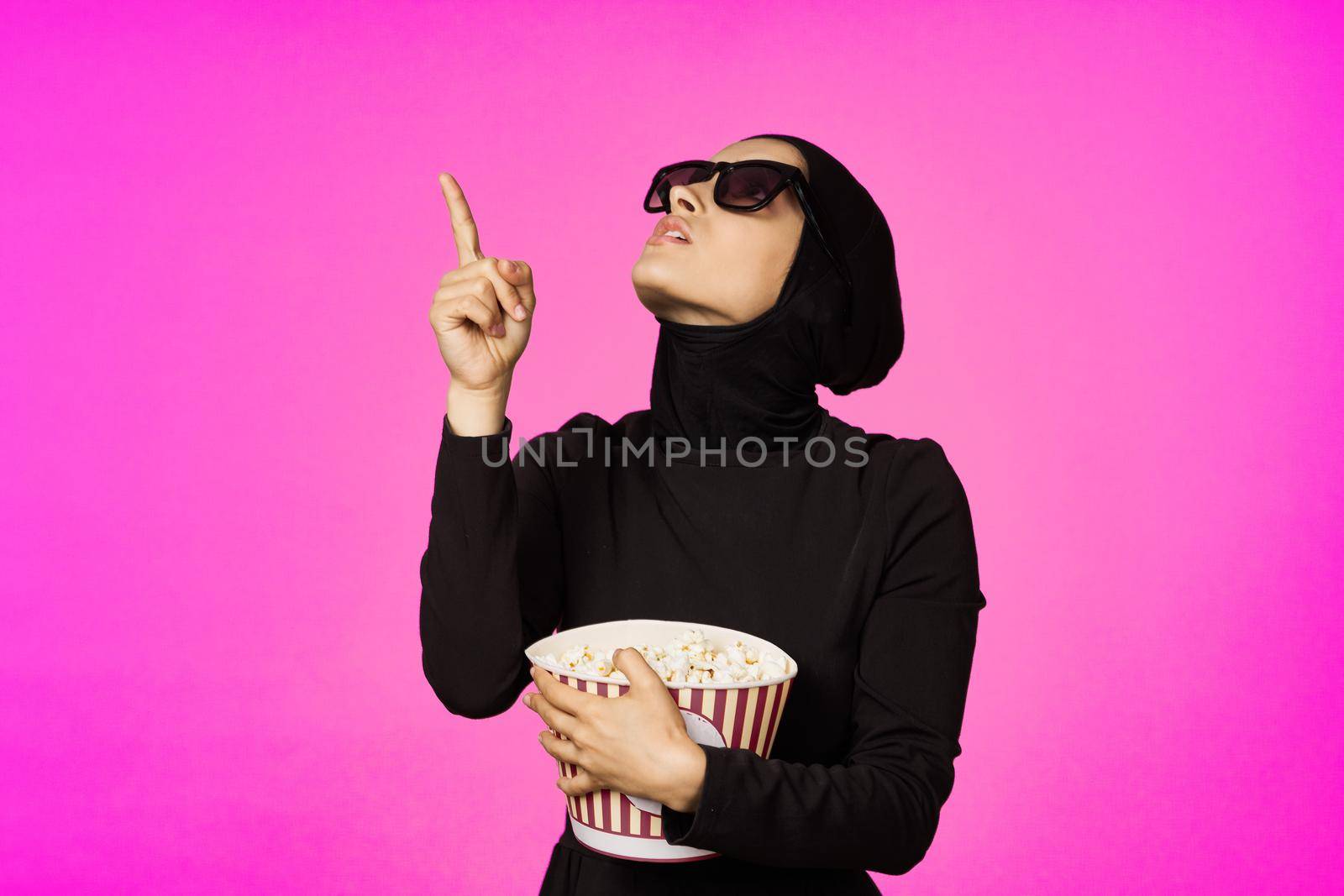 Muslim woman fun popcorn entertainment fashion isolated background. High quality photo