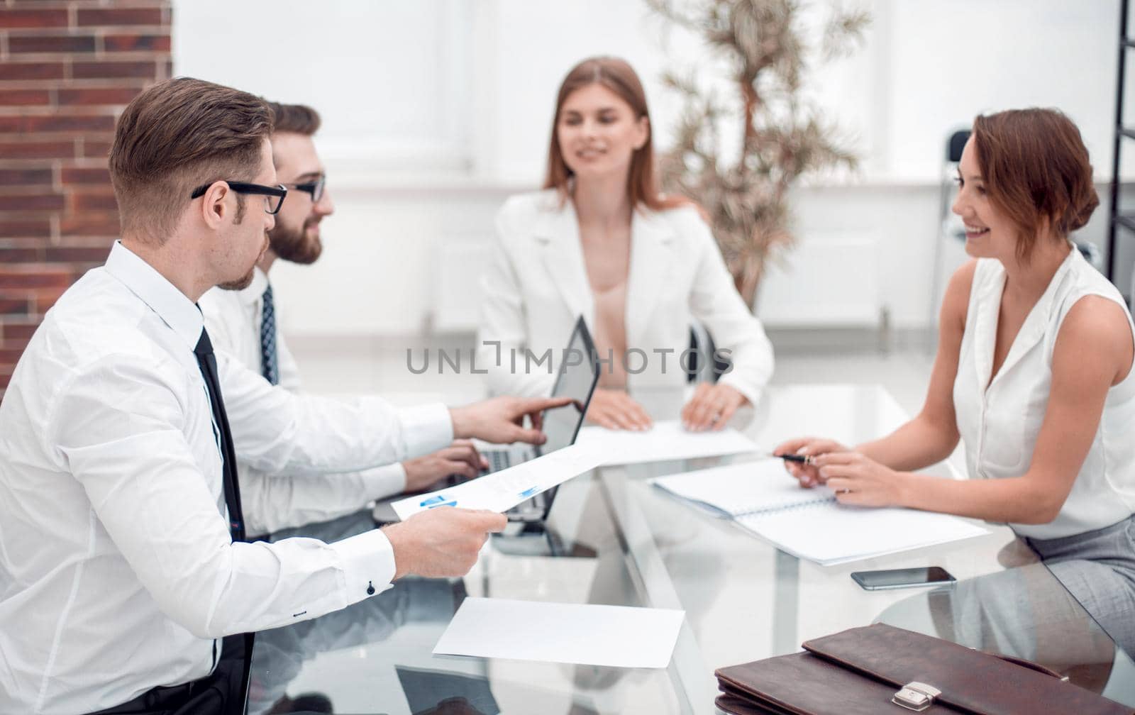 employees discussing business documents.office weekdays