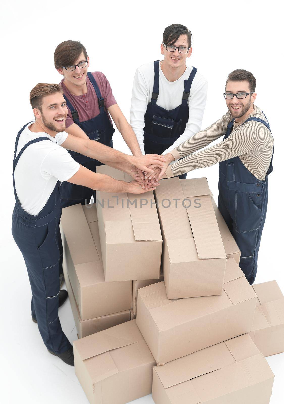 Cheerful movers leaning on stack of boxes isolated on white back by asdf